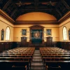 Historical lecture hall where famous physics discoveries were announced warm atmospheric lighting