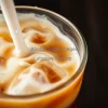 Iced cold brew with milk swirl captured in motion