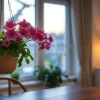 Indoor hanging planter with blooming flowers above a dining table
