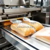 Industrial bakery packaging line with automated slicing and wrapping of bread rapid movement sharp image