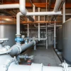 Industrial water treatment facility with large settling tanks pipes and control valves engineering focus