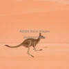 Kangaroo hopping across red desert
