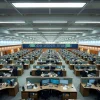 Large corporate open floor with rows of identical desks