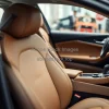 Luxury car interior assembly line leather seats dashboards being carefully fitted sophisticated atmosphere