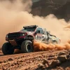 Off road rally truck roaring through a rocky desert cloud of dust