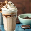 Oreo cookie coffee frappe with whipped cream and cookie crumble