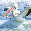 Pelican catching fish in ocean waves