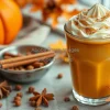 Pumpkin spice latte with whipped cream and autumn spices