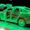 Robotic inspection system scanning car body for defects red laser lines dark background