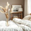 Scandinavian bedroom with dried flowers in a vase