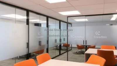 Shared office with glass partitions and frosted logos