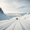 Snowy mountain pass with a single car making tire tracks dramatic vista