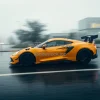 Sports car under heavy rain in slow shutter shot raindrops visible dynamic