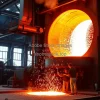Steel production plant with molten metal pouring from a large furnace sparks flying dramatic industrial atmosphere