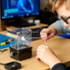 Student assembling a DIY particle detector in a home lab creative physics education setting