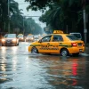 Taxi in a monsoon flooded street water halfway up wheels tropical city