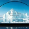 The last iceberg framed like a museum exhibit inside a giant glass dome speculative future