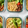 Top view of meal prep containers filled with lean protein grains and vegetables