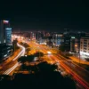 Urban night scene with streaks of car lights long exposure from above