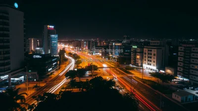 Urban night scene with streaks of car lights long exposure from above