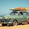 Vintage car with surfboards on roof at a crowded summer beach golden sand