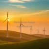 Wind turbines on rolling green hills during golden hour