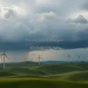 Wind turbines on rolling green hills under dramatic storm clouds high resolution landscape photo